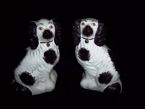 Appraisal: A pair of Staffordshire black and white dogs cm high