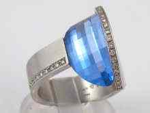 Appraisal: A platinum diamond and blue topaz ring designed by ''Bunz''