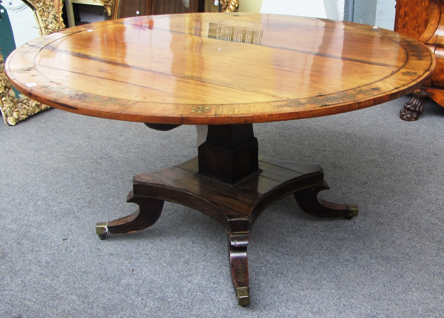 Appraisal: A Regency brass inlaid rosewood breakfast table the circular snap