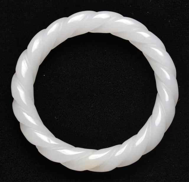 Appraisal: Chinese Carved White Jade Twisted BangleFinely polished white jade bangle