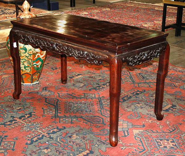 Appraisal: A hardwood side table with carved and scalloped aprons Late