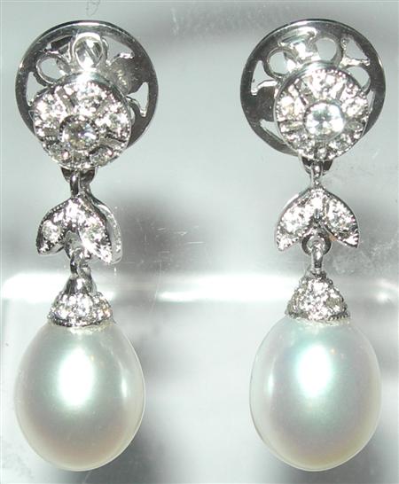 Appraisal: A pair of pearl and diamond pendant earrings each composed