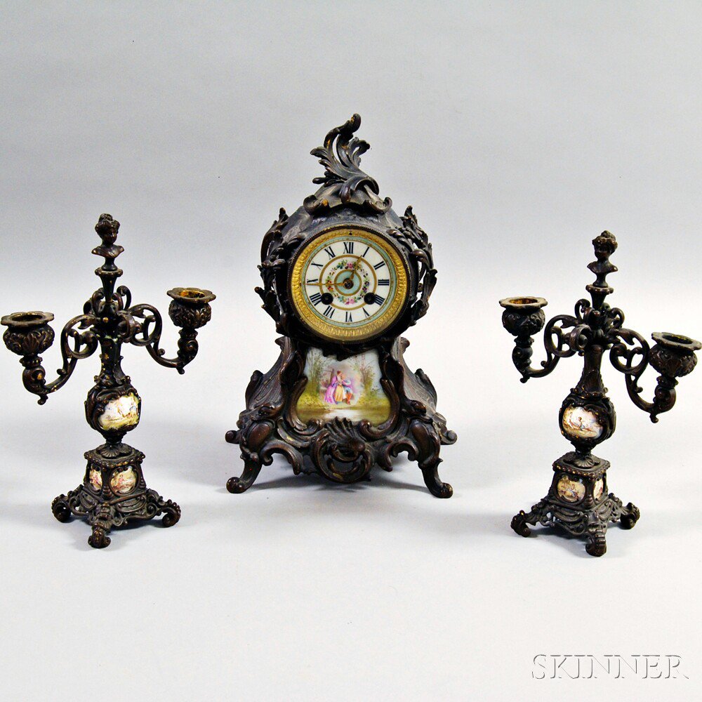 Appraisal: French Bronze and Porcelain Clock and Garniture Set France c