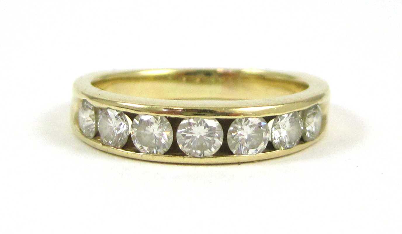 Appraisal: DIAMOND AND FOURTEEN KARAT GOLD RING channel set with a