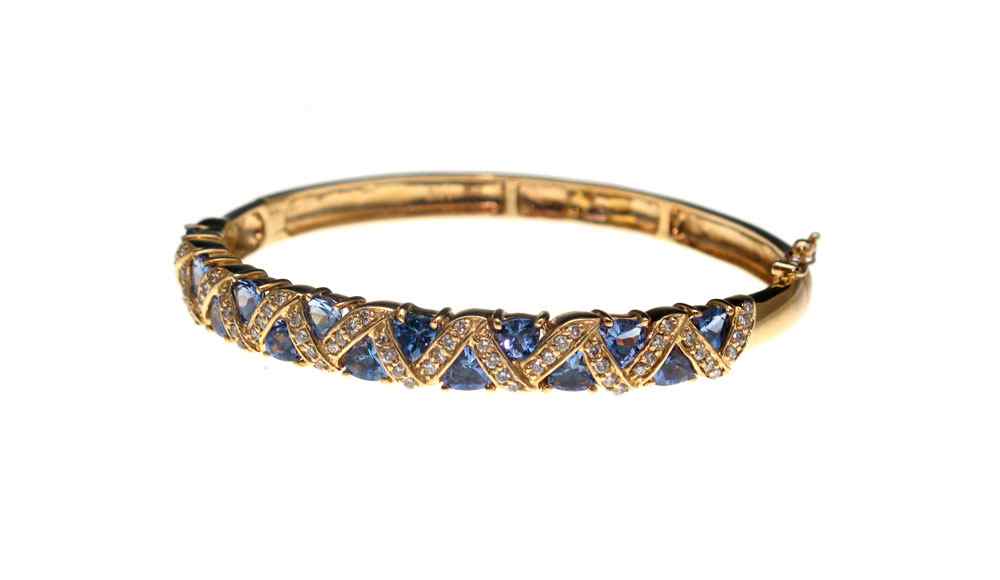 Appraisal: K DIAMOND AND TANZANITE BANGLE BRACELET K yellow gold bangle