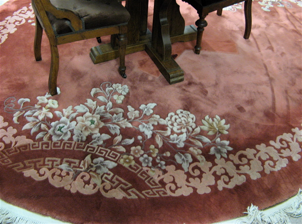 Appraisal: AN OVAL CHINESE CARPET hand knotted with floral border on