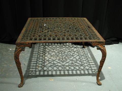 Appraisal: WROUGHT IRON GARDEN TABLE The square pierced top rasied on