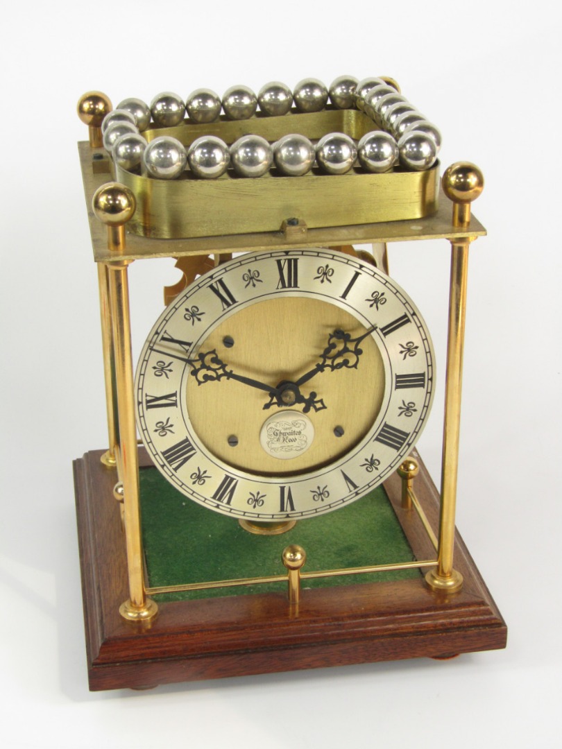 Appraisal: A Thwaites Reed brass rolling ball clock with an open