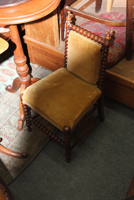 Appraisal: A VICTORIAN WALNUT CHILD'S CHAIR with bobbin turned cresting rail