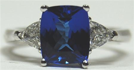 Appraisal: A contemporary Tanzanite and diamond three-stone ring corner claw set