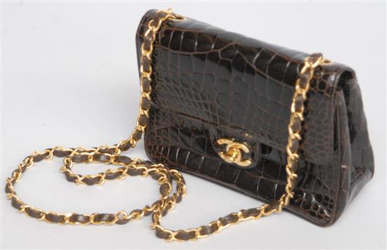 Appraisal: A CHANEL ALLIGATOR BAG Having a gilt and leather shoulder