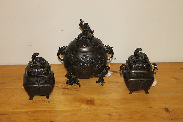 Appraisal: A CHINESE BRONZE CENSER and cover with raised dragon on