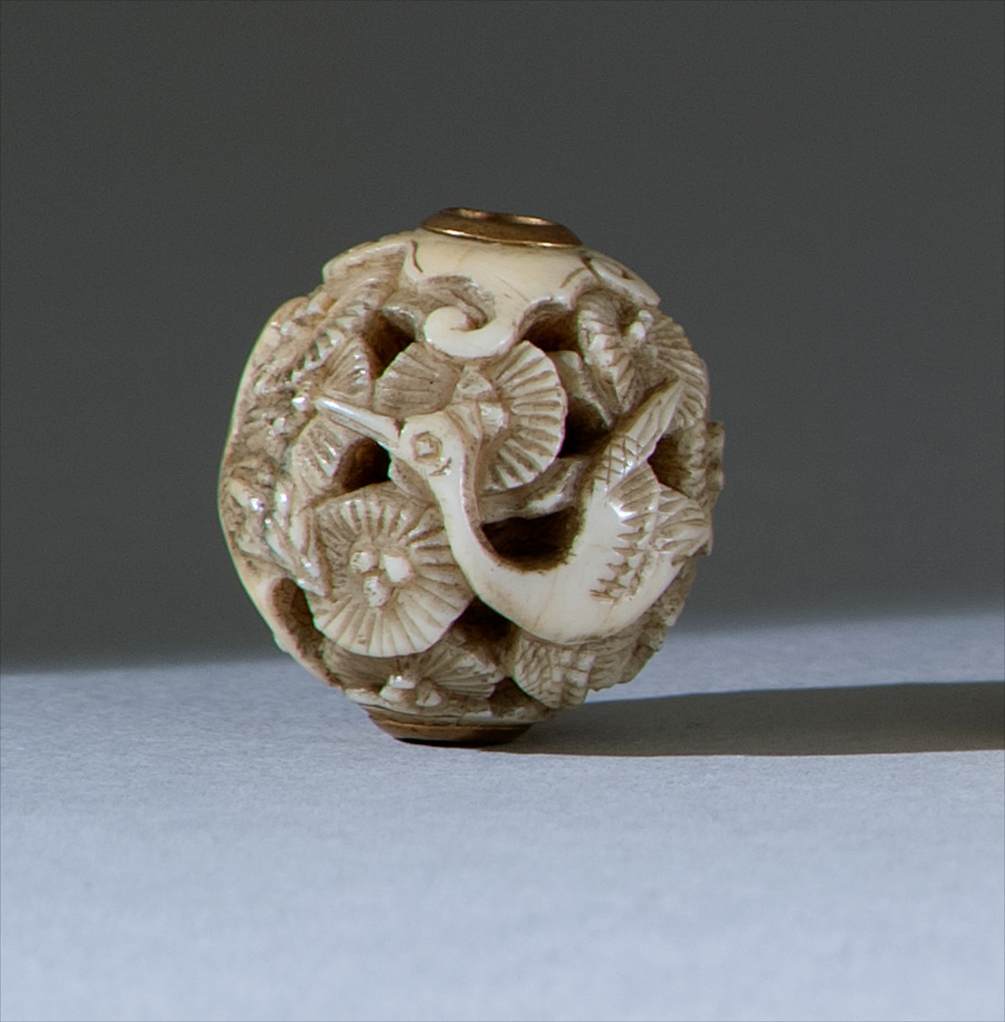 Appraisal: IVORY OJIME Late th CenturyIn ball form with openwork crane