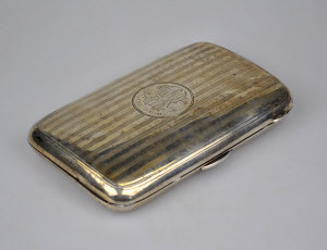 Appraisal: A silver cheroot case with engraved decoration and engine-turned decoration