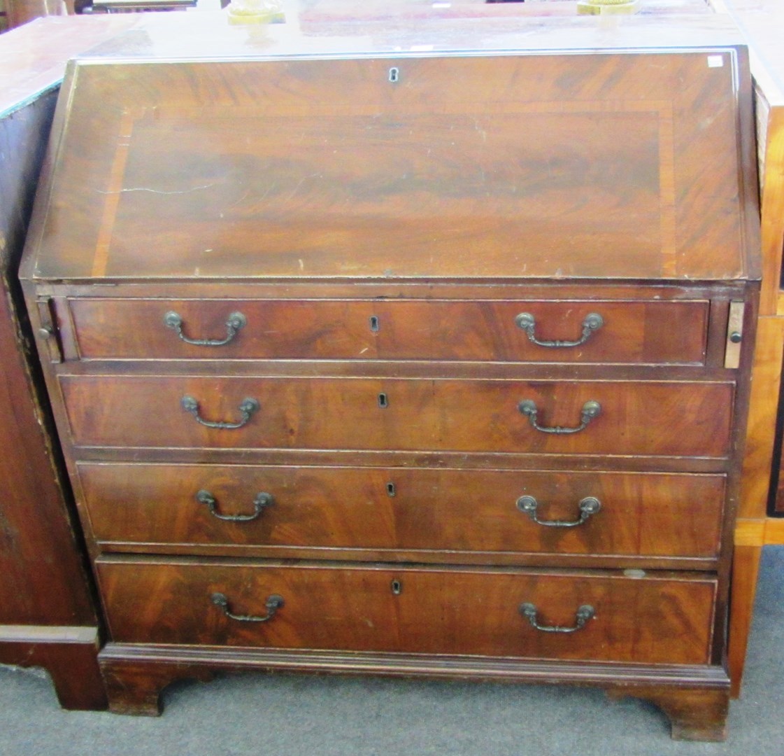 Appraisal: A George III mahogany bureau the fall over four long