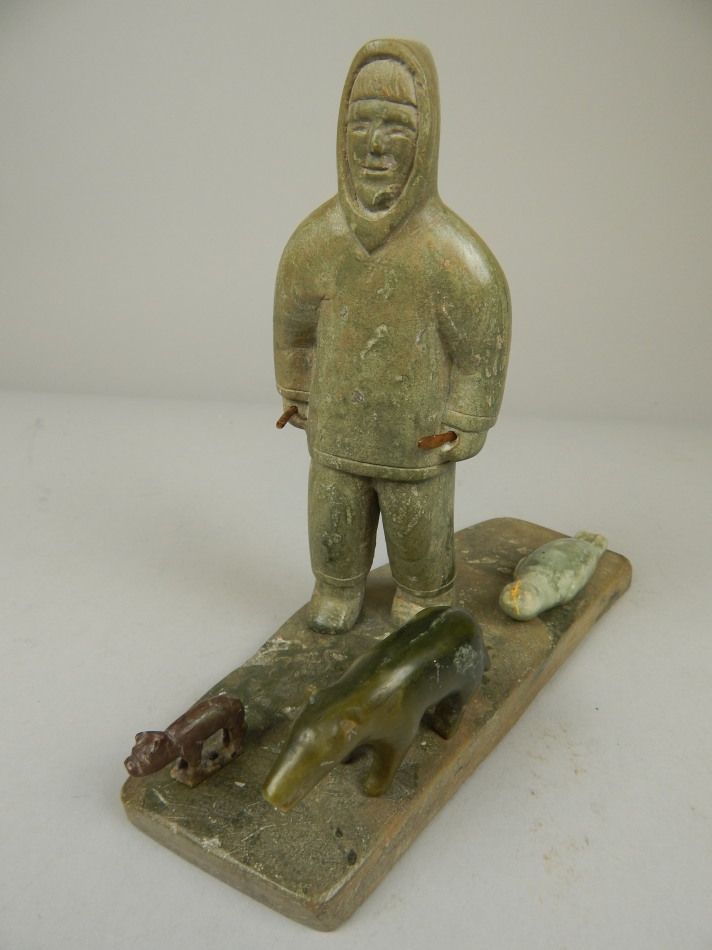 Appraisal: An Inuit soapstone carving in the form of an Eskimo