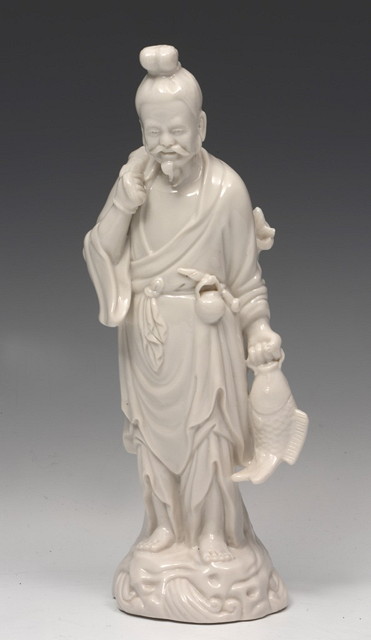 Appraisal: A CHINESE BLANC DE CHINE FIGURE of fishermen holding a