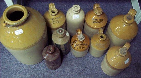 Appraisal: A stoneware storage jar with sundry smaller jars and hot