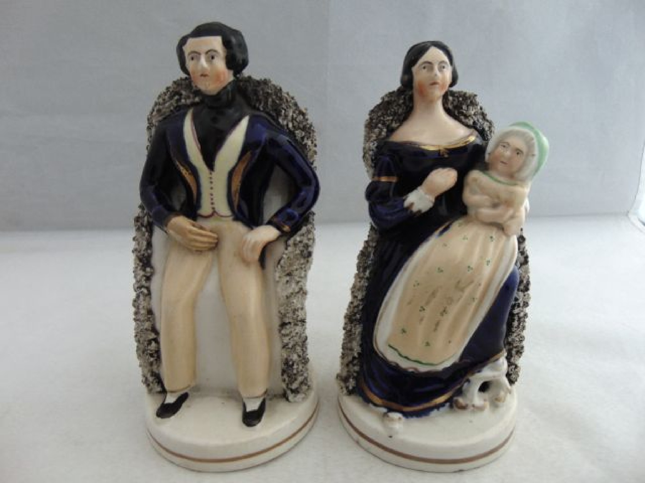 Appraisal: A pair of th century Staffordshire figures of seated figures