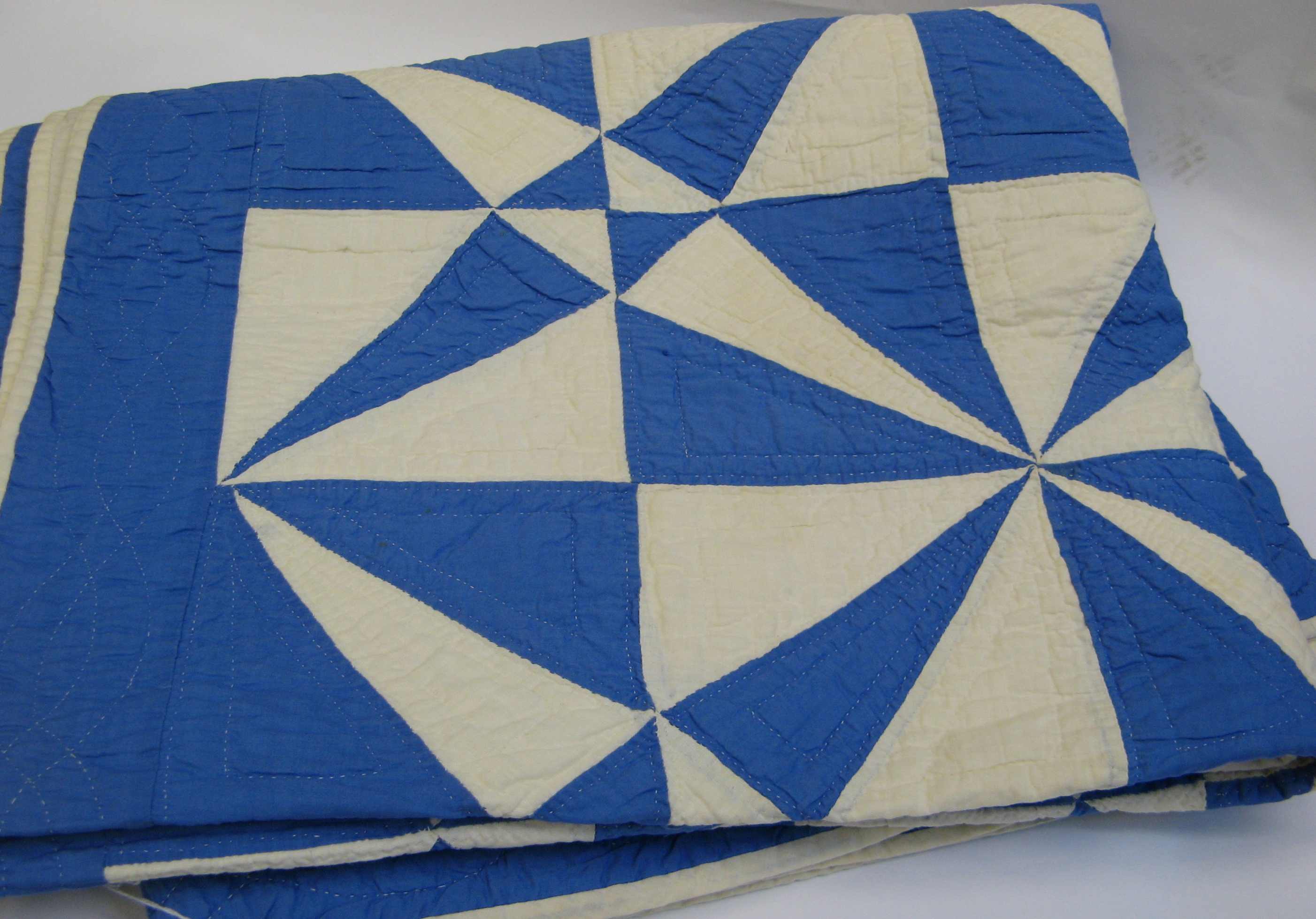 Appraisal: AN AMERICAN PIECED HANDMADE PATCHWORK QUILT blue and white cotton