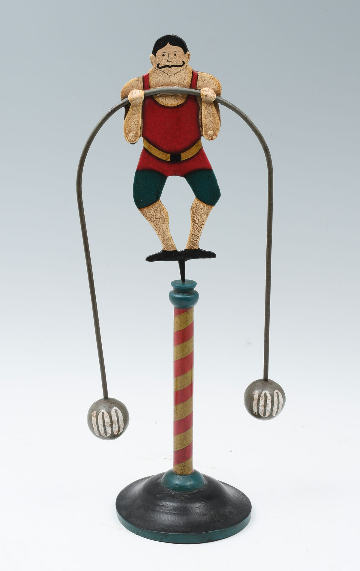 Appraisal: BALANCING WEIGHT LIFTER SCULPTURE A whimsical polychromed steel weightlifter balancing