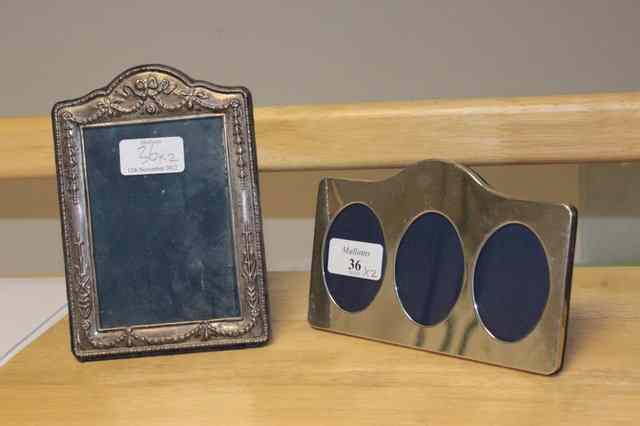 Appraisal: A SILVER PHOTOGRAPH FRAME with three oval apertures wide together