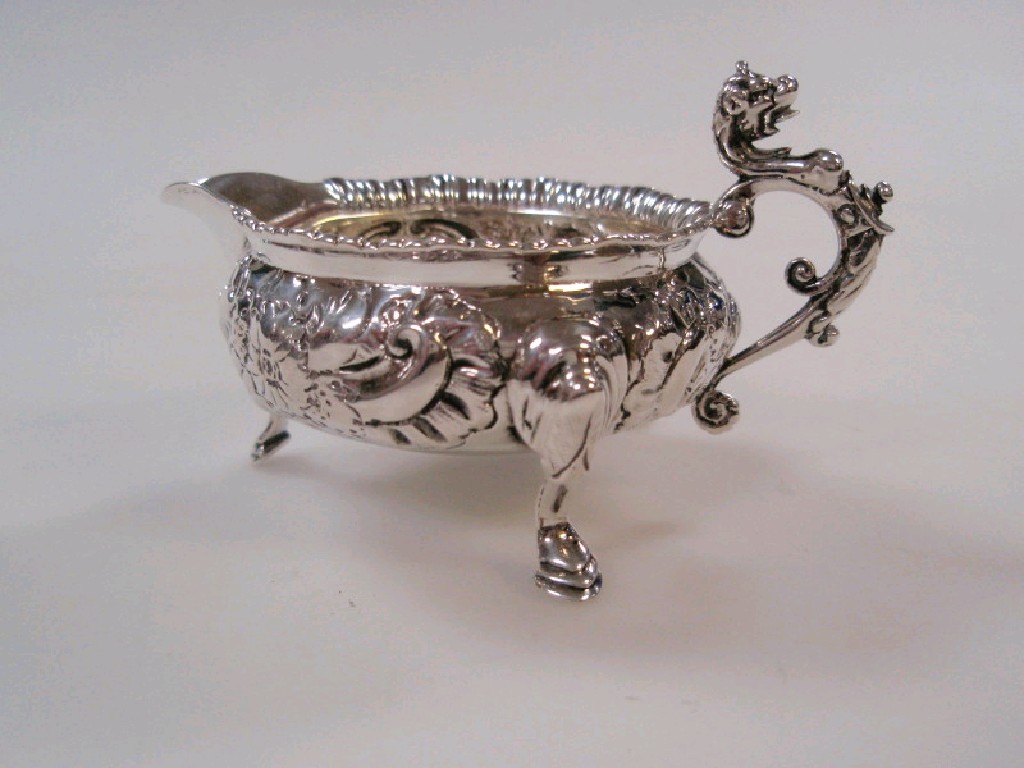 Appraisal: A small Victorian silver jug on three hoofed feet sea