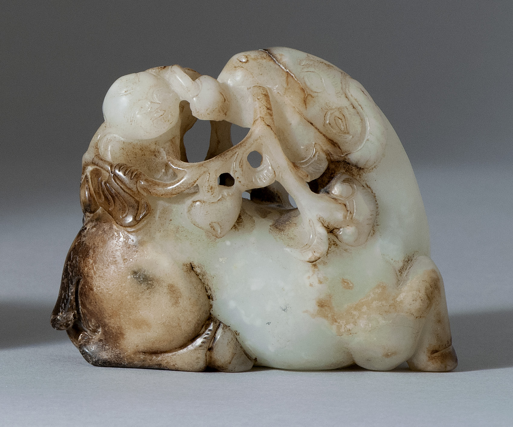 Appraisal: WHITE AND BROWN JADE CARVING th th CenturyDepicting a child