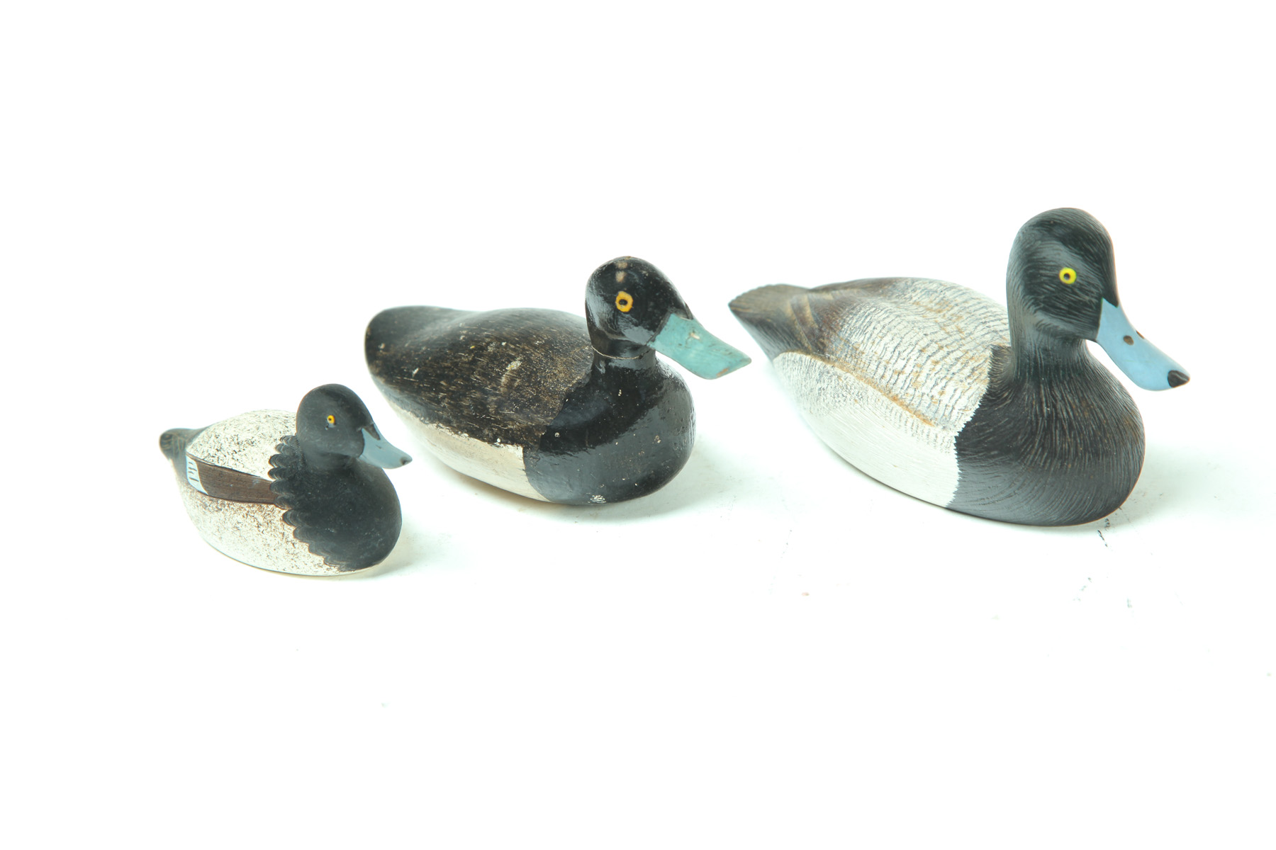 Appraisal: THREE MINIATURE DUCK CARVINGS American nd half- th century Original