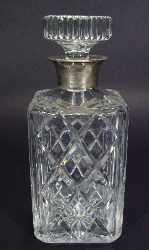 Appraisal: Square based cut glass decanter and stopper with silver collar