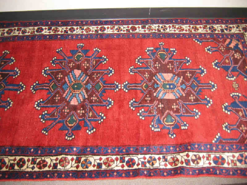 Appraisal: HAMADAN RUNNER The red field shows three geometric medallions within