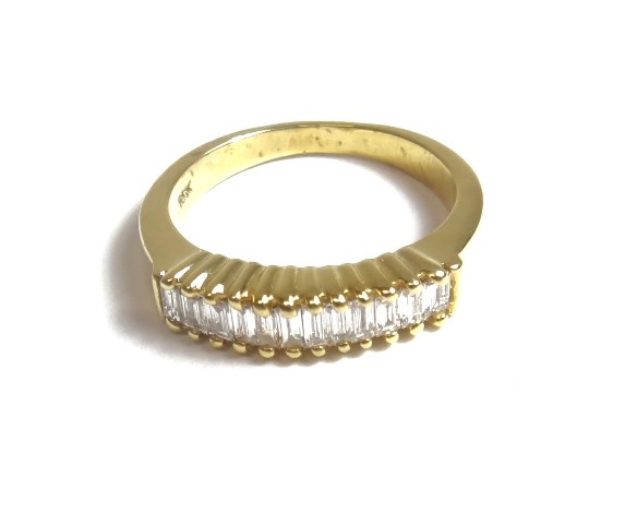 Appraisal: A gold and baguette diamond set half hoop ring mounted