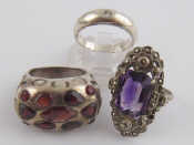 Appraisal: Three white metal tests silver rings one amethyst one garnet