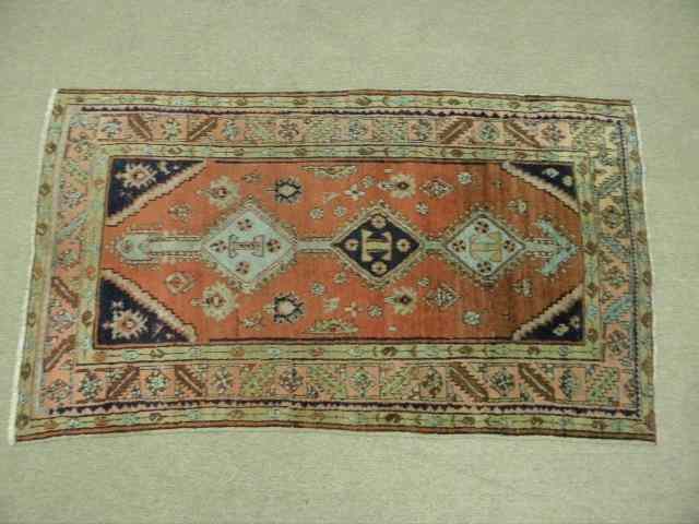 Appraisal: Caucasian area rug hand knotted with colors of red dark