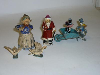 Appraisal: Various metal figures Mickey Mouse pushed in a wheelbarrow by