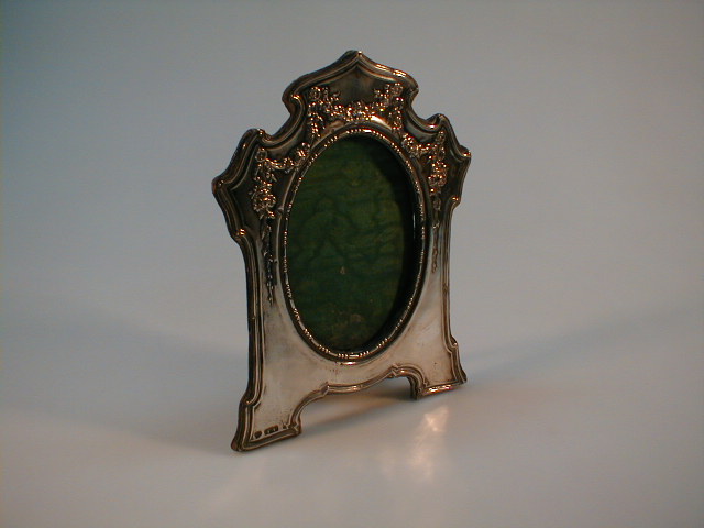 Appraisal: A silver rococo style frame with oval inset Birmingham assay