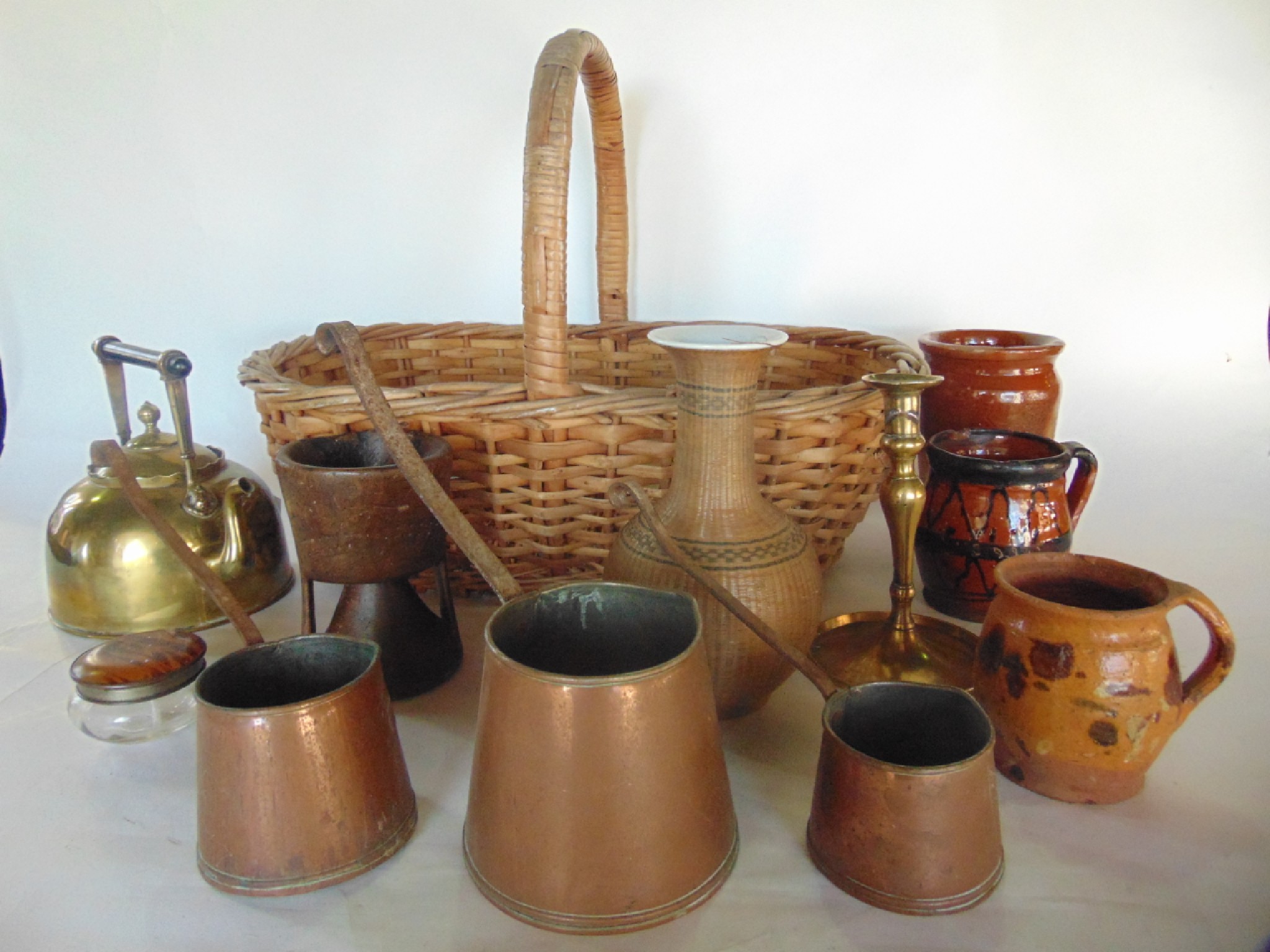 Appraisal: A large antique wicker basket accommodating a graduating trio of