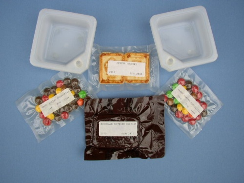 Appraisal: Shuttle Sweets Two packages of candy coated chocolates M M's