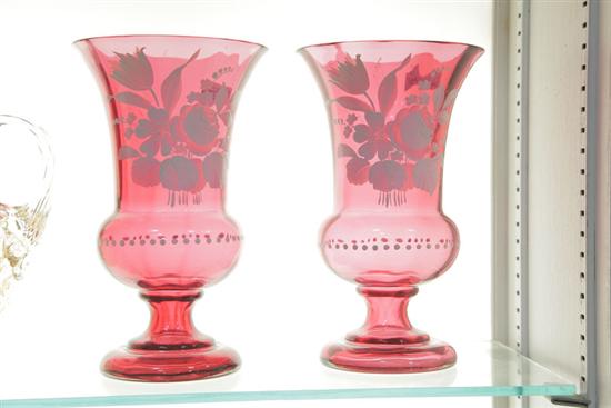 Appraisal: TWO CRANBERRY GLASS VASES Having white enameled floral decoration ''h