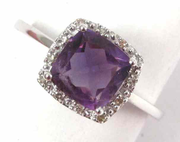 Appraisal: AMETHYST AND FOURTEEN KARAT GOLD RING white gold with round-cut