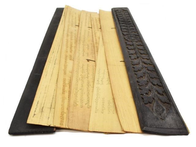 Appraisal: Tibetan Buddhist sutra within black foliate-carved wood covers ten palm