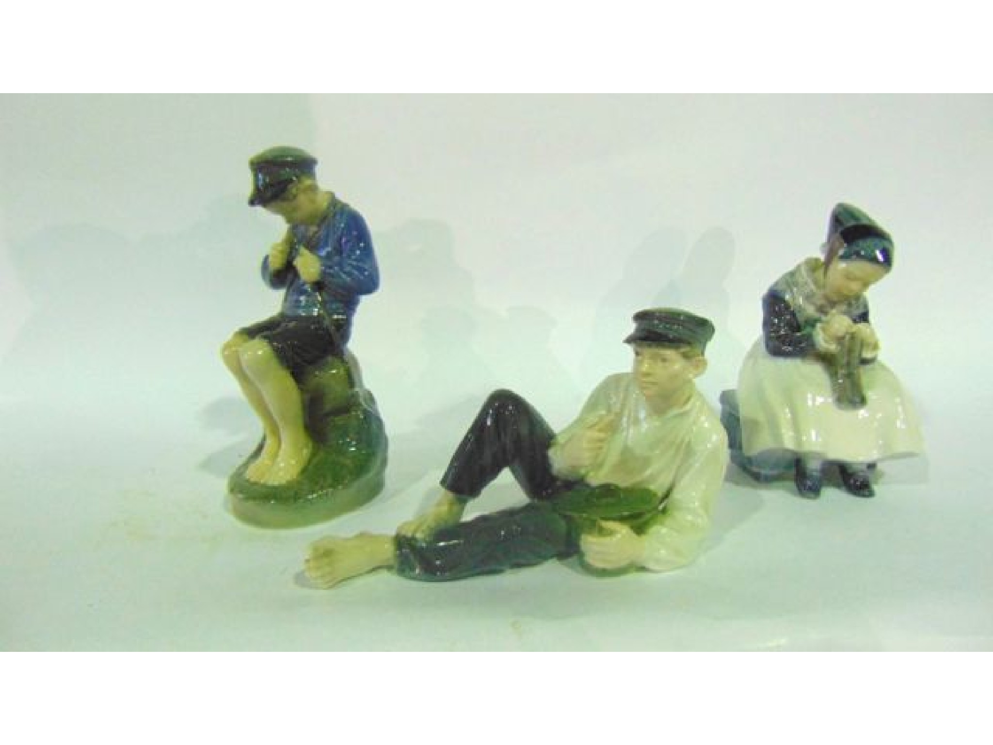 Appraisal: A collection of three Royal Copenhagen figures including a seated