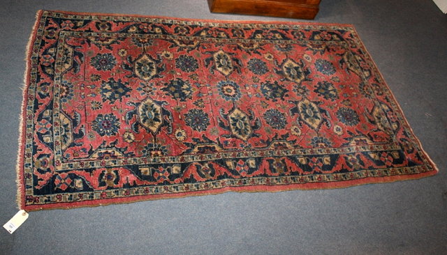 Appraisal: A PERSIAN PINK GROUND RUG with all over stylised foliate