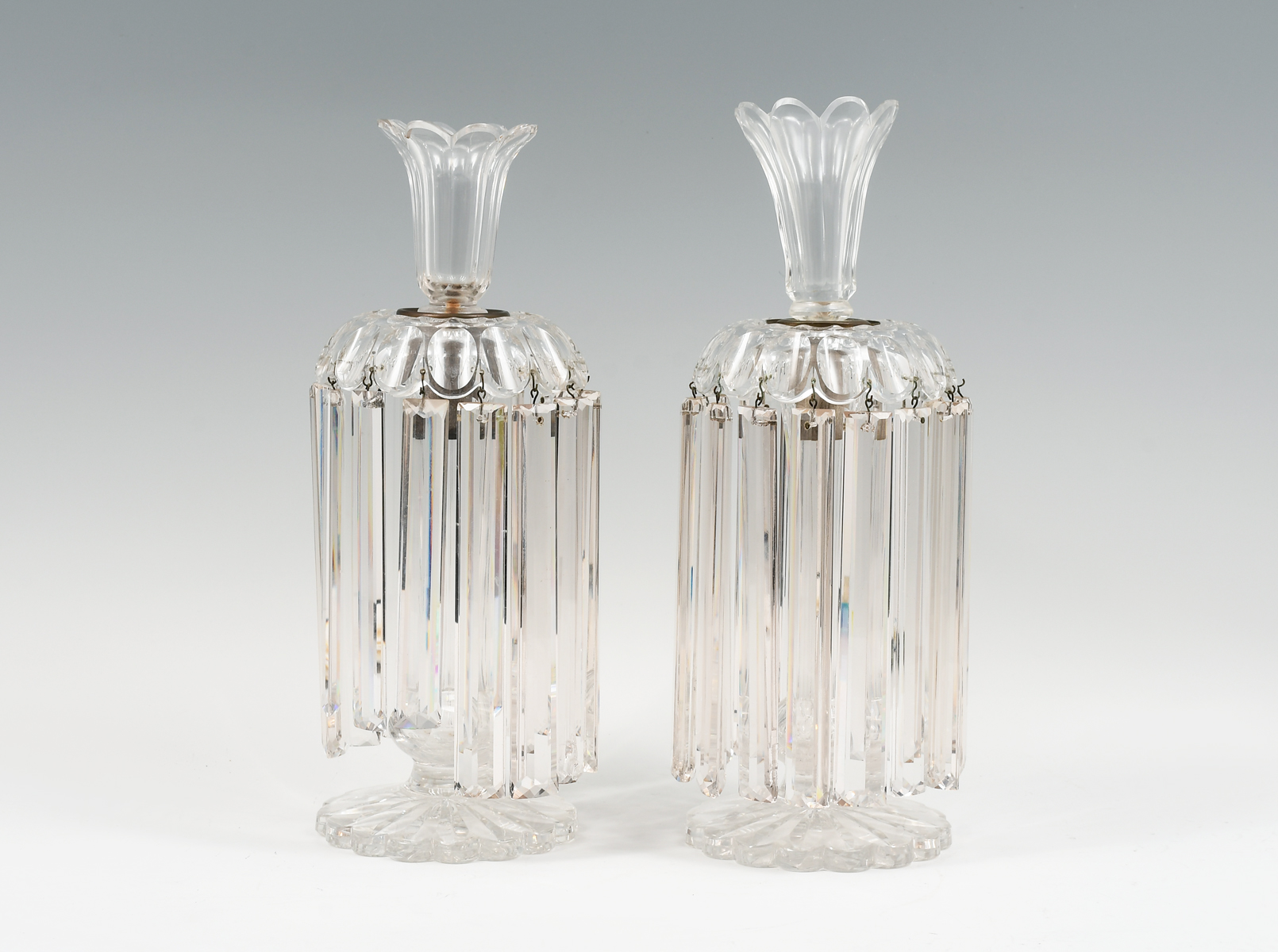 Appraisal: PAIR OF CRYSTAL LUSTRES Surmounting floriform finials over Lustres with