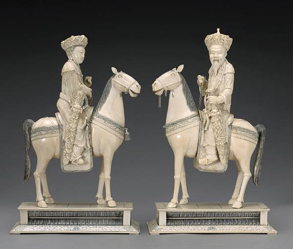 Appraisal: A pair of pieced and tinted ivory figures of an