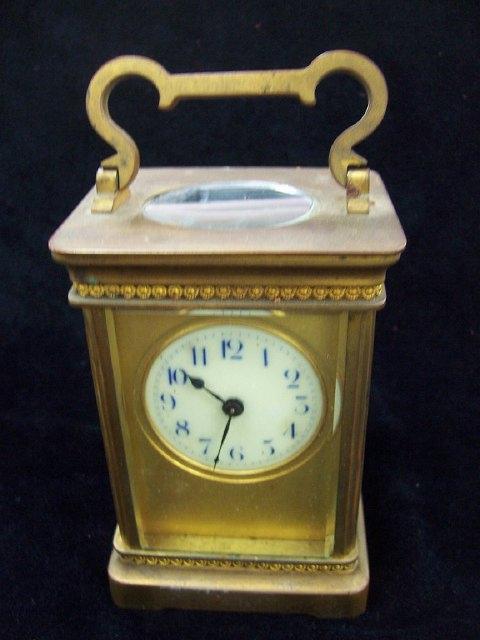 Appraisal: A gilt brass carriage clock with plain white enamel dial