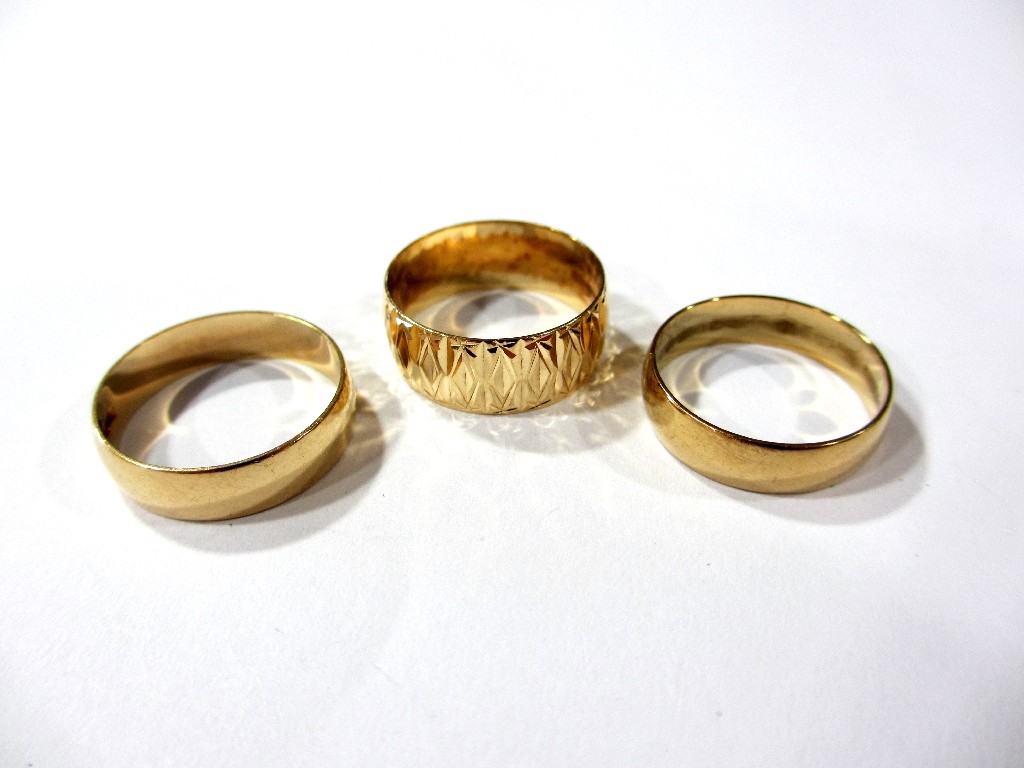 Appraisal: Three ct gold wedding bands two plain and one bright