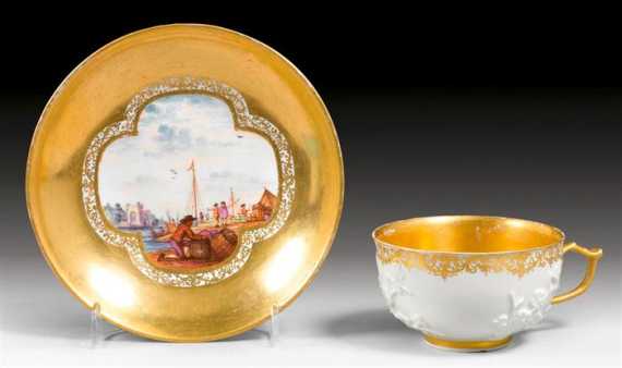 Appraisal: CUP AND SAUCER WITH FLORAL RELIEF AND MERCHANT SCENES Meissen