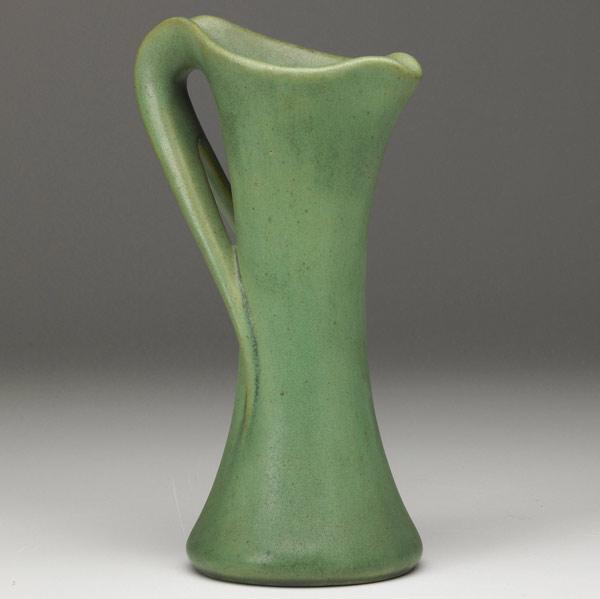 Appraisal: TECO Pitcher with whiplash handle covered in matte green glaze