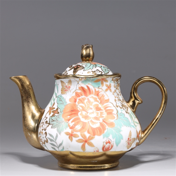 Appraisal: Chinese gilt porcelain teapot with floral designs to body and